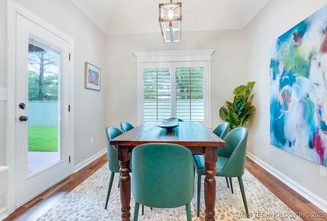 dining room with baseboards and wood finished floors
