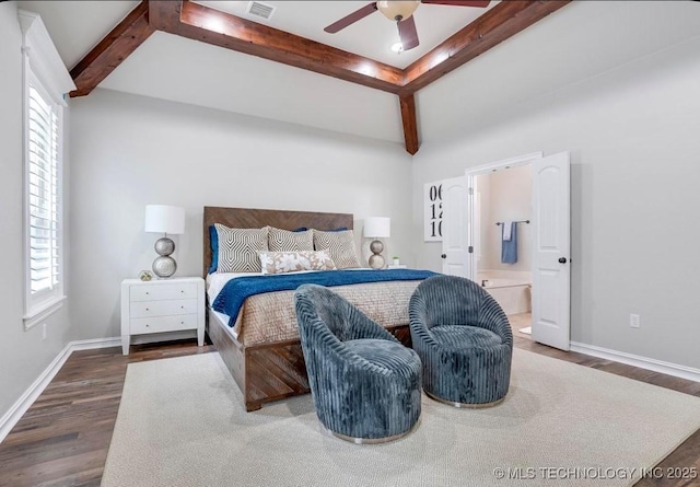 bedroom with visible vents, baseboards, ensuite bath, and wood finished floors