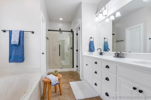 full bathroom featuring double vanity, a sink, tile patterned flooring, and a stall shower