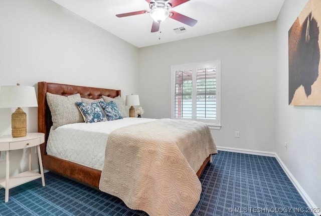 carpeted bedroom with a ceiling fan, baseboards, and visible vents