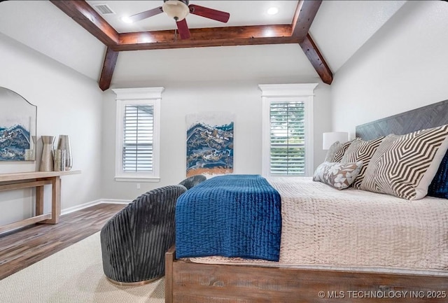 bedroom featuring visible vents, wood finished floors, and vaulted ceiling with beams