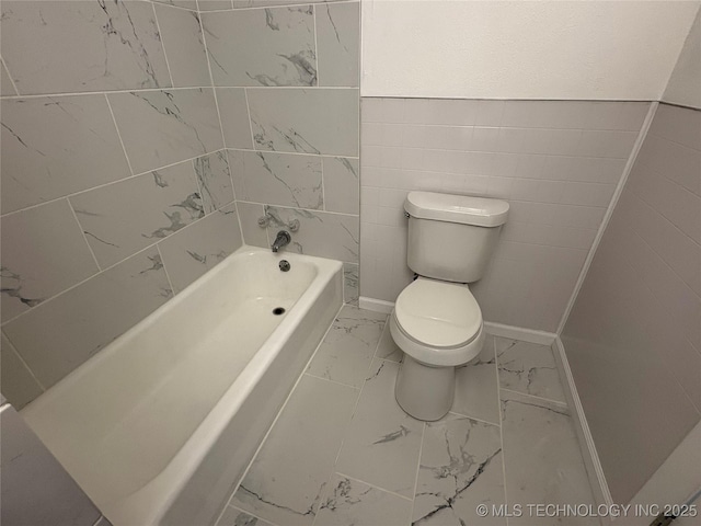 full bathroom featuring toilet and marble finish floor