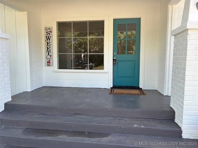 view of exterior entry with covered porch