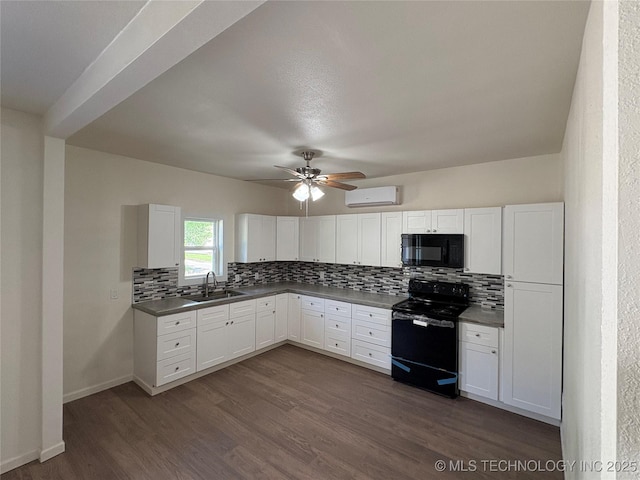 kitchen featuring a wall mounted AC, tasteful backsplash, a sink, dark wood finished floors, and black appliances