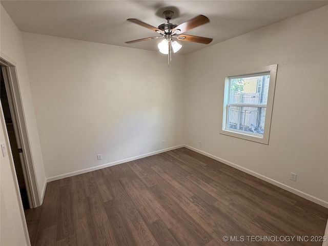 unfurnished room with baseboards, ceiling fan, and dark wood-style floors