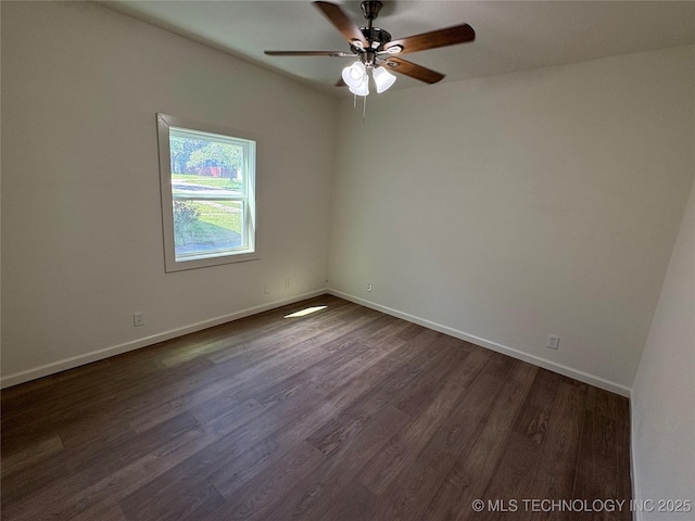 unfurnished room featuring a ceiling fan, baseboards, and dark wood-type flooring