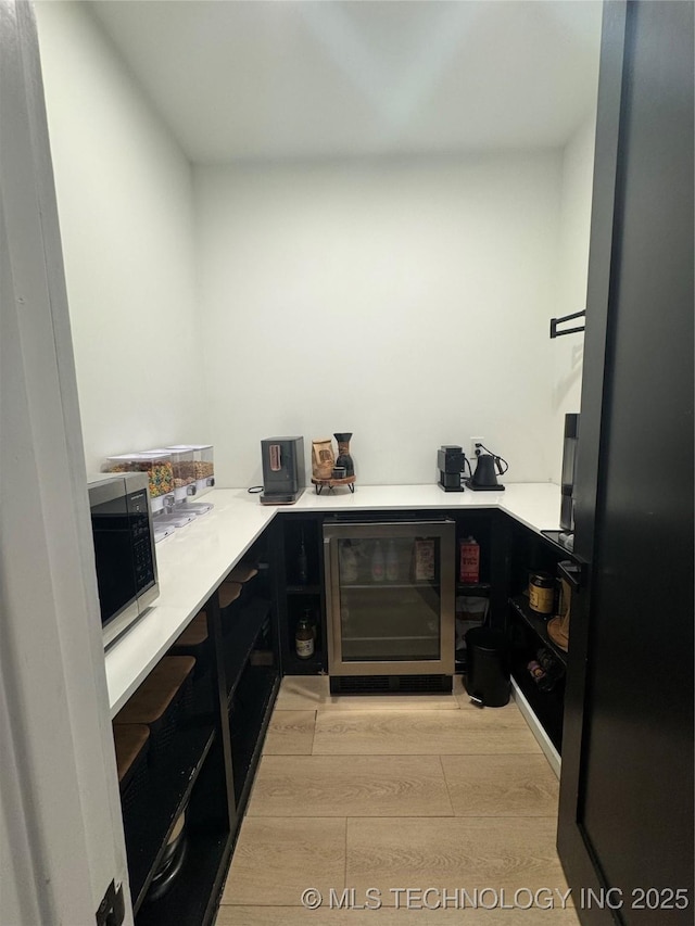 1583 E Clara Ct, Fort Gibson, OK 74434 - bar featuring beverage cooler, stainless steel microwave, and light wood finished floors