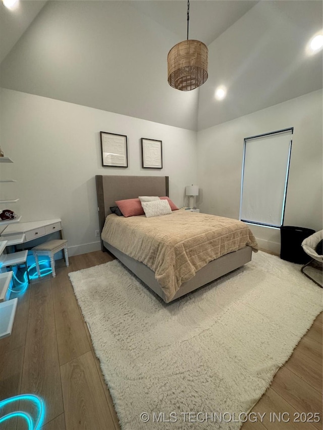 1583 E Clara Ct, Fort Gibson, OK 74434 - bedroom with high vaulted ceiling, baseboards, and wood finished floors