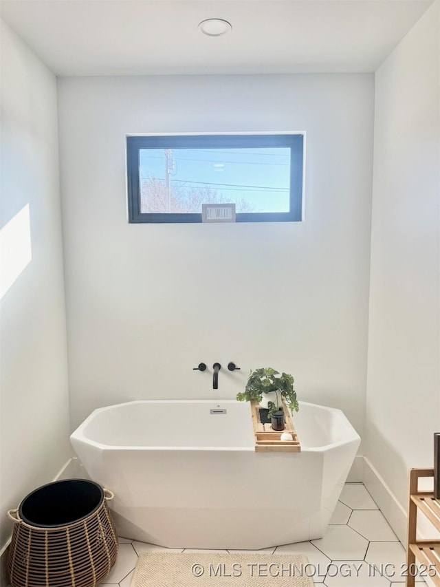 1583 E Clara Ct, Fort Gibson, OK 74434 - full bath with tile patterned flooring, a freestanding tub, and plenty of natural light