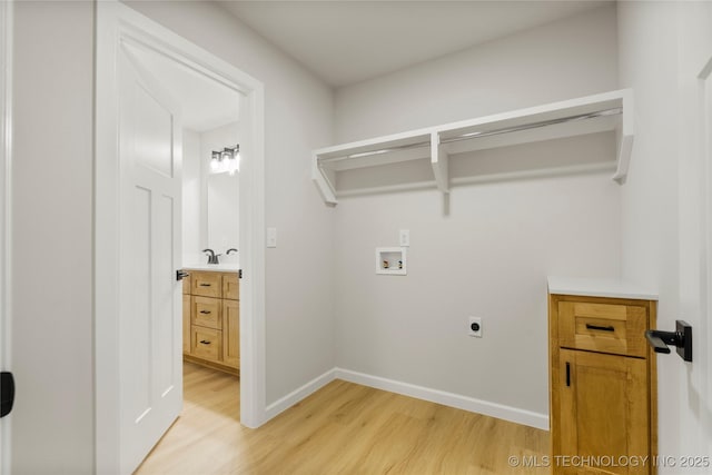 laundry room with washer hookup, laundry area, baseboards, light wood-type flooring, and hookup for an electric dryer