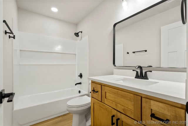 full bathroom with vanity, shower / bathtub combination, toilet, recessed lighting, and wood finished floors