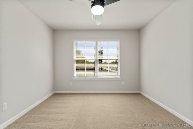 empty room with baseboards, light carpet, and a ceiling fan