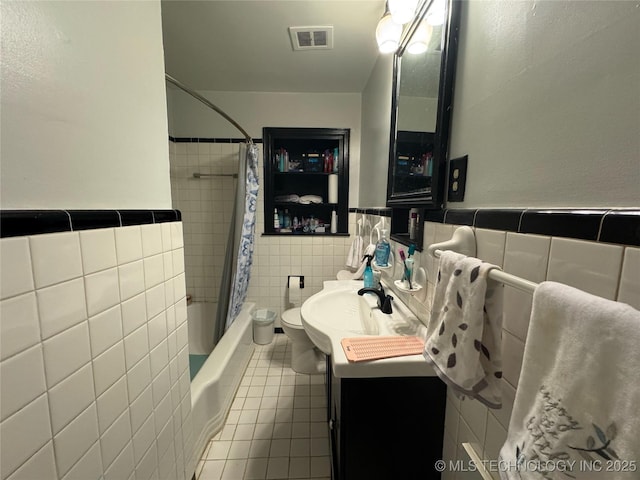 3210 Summit Blvd, Sand Springs, OK 74063 - bathroom with tile walls, tile patterned flooring, vanity, shower / bath combo with shower curtain, and wainscoting