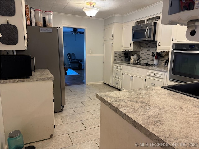 3210 Summit Blvd, Sand Springs, OK 74063 - kitchen featuring stainless steel appliances, crown molding, white cabinetry, tasteful backsplash, and a ceiling fan