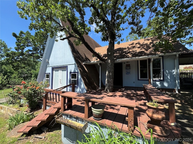 back of house featuring french doors and a wooden deck