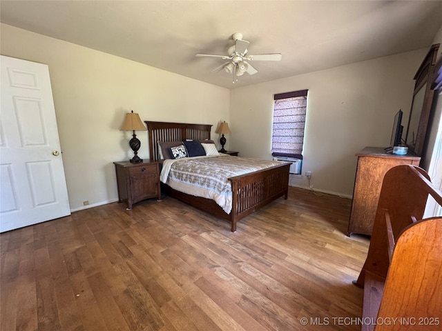 bedroom featuring baseboards, ceiling fan, and wood finished floors