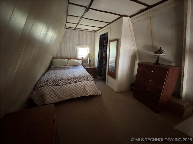 bedroom featuring wooden walls and carpet