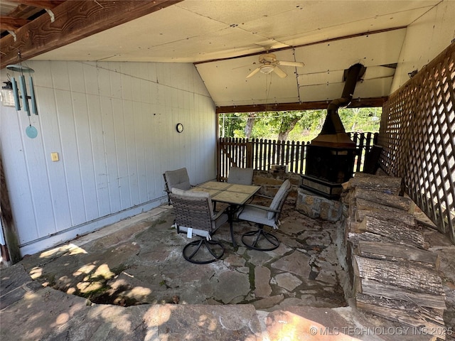 view of patio featuring fence, a ceiling fan, and outdoor dining area