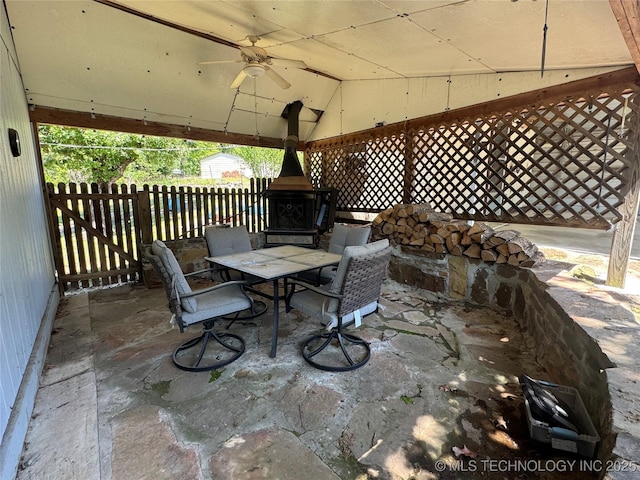 view of patio / terrace featuring fence, outdoor dining space, ceiling fan, and a gazebo
