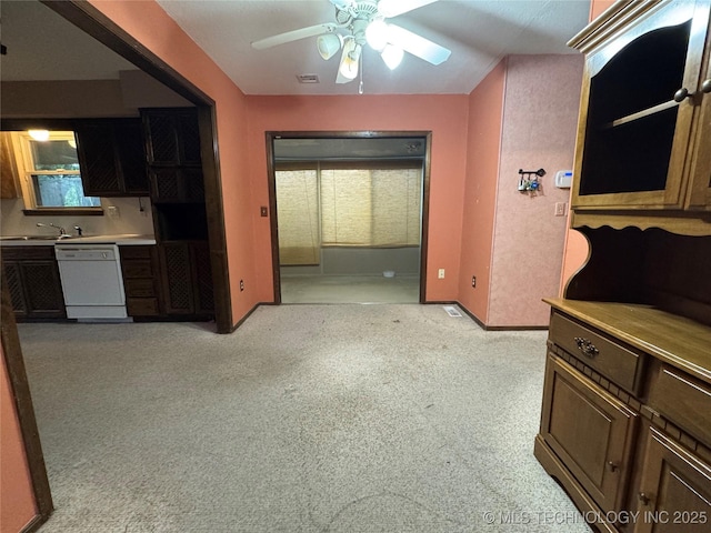 interior space with baseboards, visible vents, multiple windows, and a sink