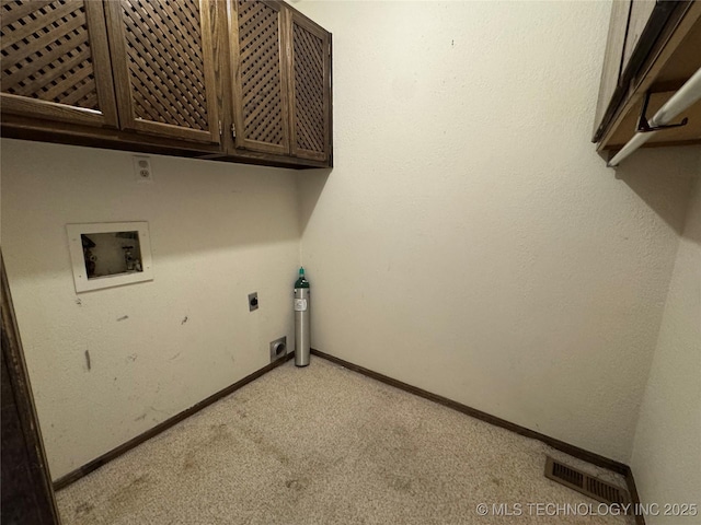 laundry area featuring cabinet space, washer hookup, light colored carpet, electric dryer hookup, and visible vents