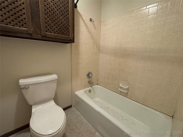 bathroom featuring toilet, baseboards, washtub / shower combination, and tile patterned flooring