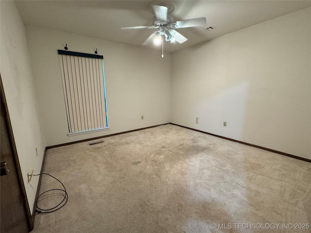 unfurnished room featuring carpet floors, baseboards, a ceiling fan, and visible vents