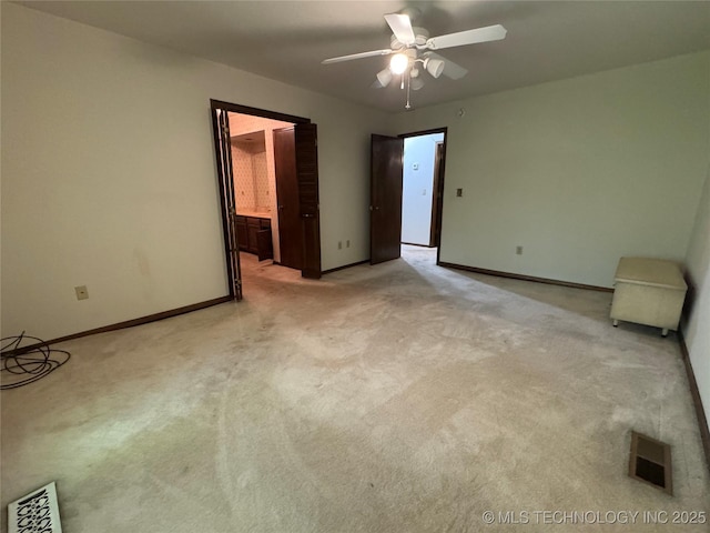 unfurnished bedroom with connected bathroom, baseboards, visible vents, and light carpet