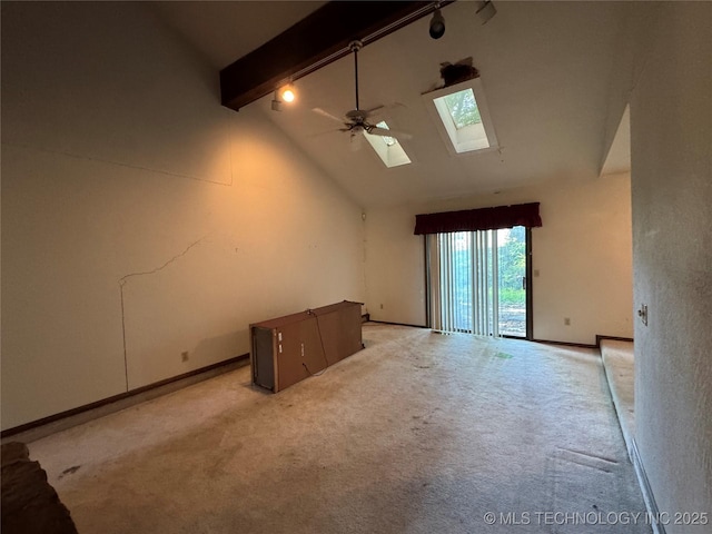 interior space featuring light carpet, beam ceiling, high vaulted ceiling, a ceiling fan, and a skylight