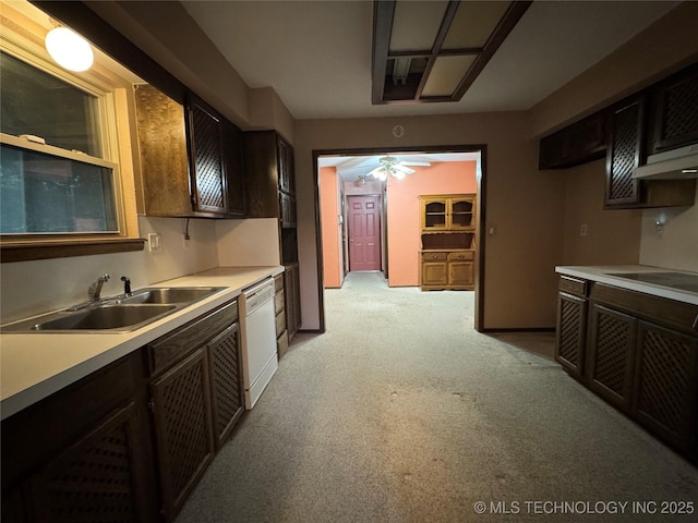 kitchen featuring white dishwasher, light countertops, a ceiling fan, and a sink