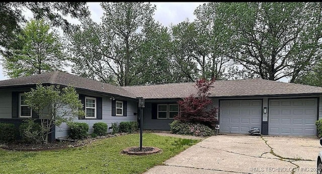 ranch-style house with roof with shingles, an attached garage, concrete driveway, and a front lawn