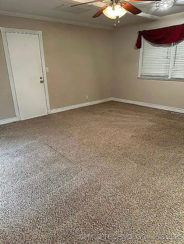 empty room featuring carpet floors, a ceiling fan, baseboards, and ornamental molding