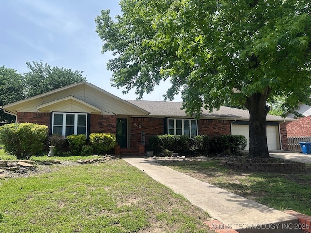 602 Flamingo Rd, Mcalester, OK 74501 - ranch-style house featuring a front yard, brick siding, and a garage