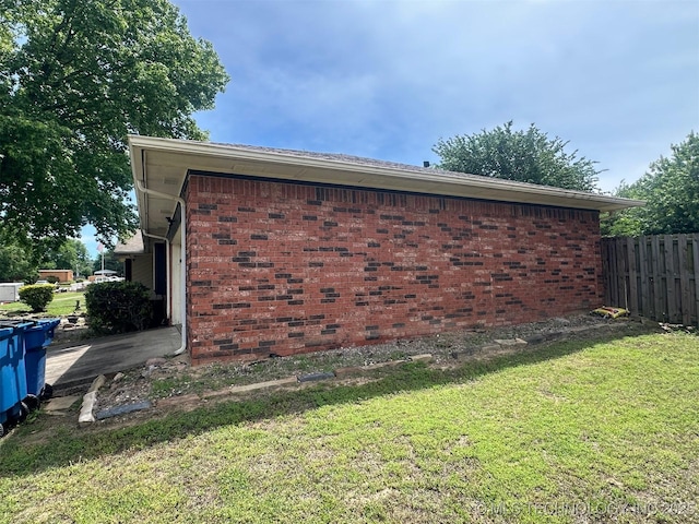602 Flamingo Rd, Mcalester, OK 74501 - view of property exterior featuring a yard, fence, and brick siding