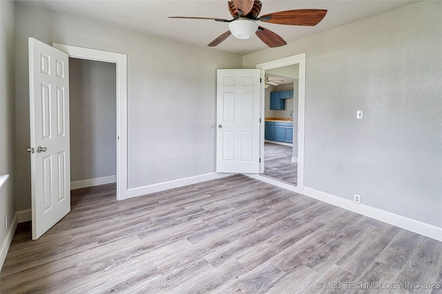 unfurnished bedroom with baseboards, ceiling fan, and wood finished floors