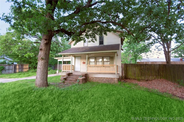 view of front of home with fence, a porch, and a front yard