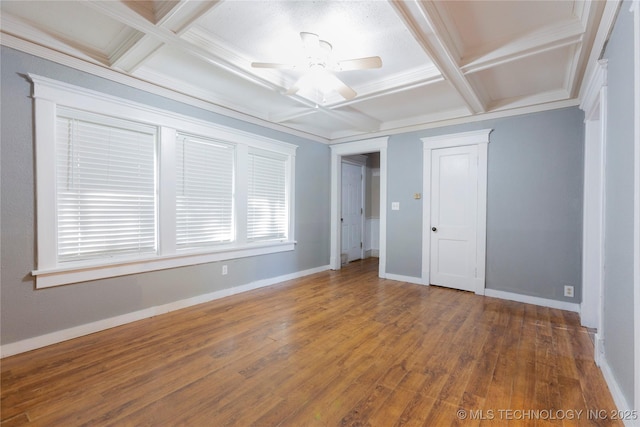 unfurnished bedroom with baseboards, coffered ceiling, beam ceiling, and wood finished floors
