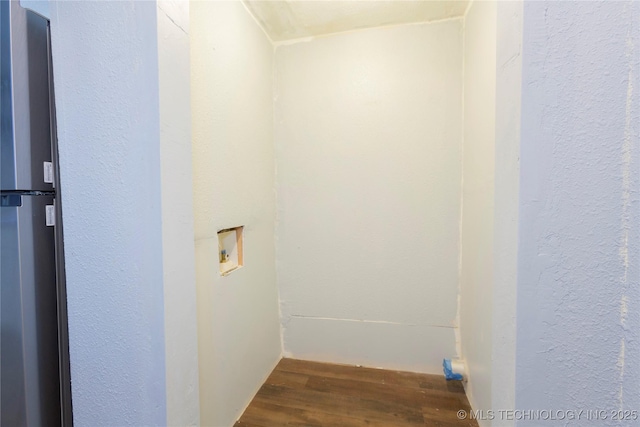 washroom with washer hookup, a textured wall, laundry area, and wood finished floors