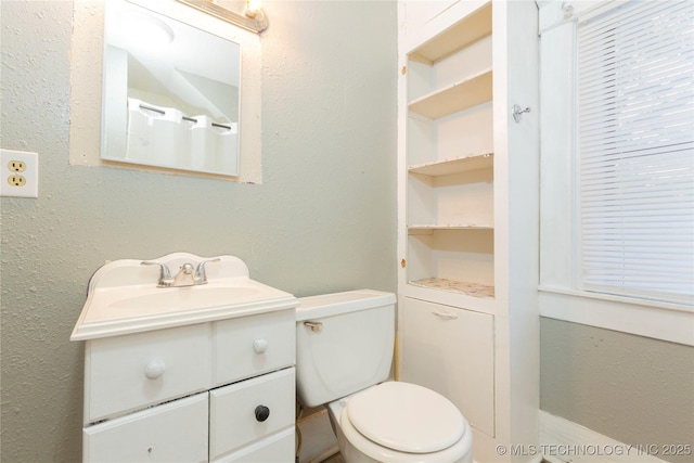 bathroom featuring toilet and vanity
