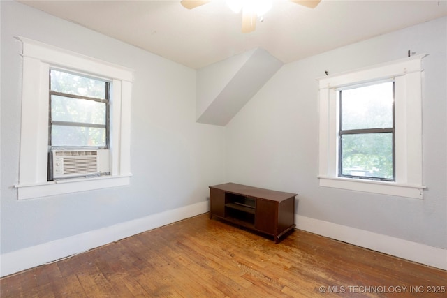 bonus room with a ceiling fan, a wealth of natural light, and light wood-style flooring