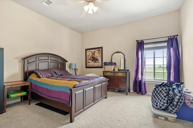 carpeted bedroom with visible vents, baseboards, and ceiling fan