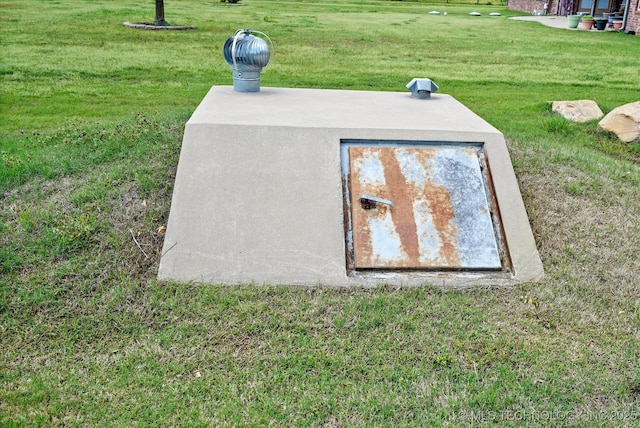 view of storm shelter featuring a yard