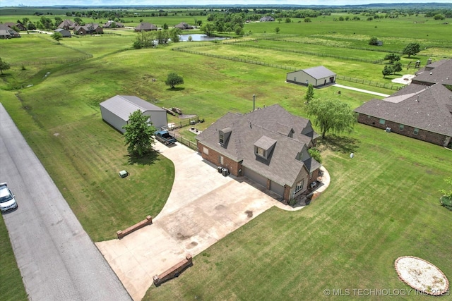 drone / aerial view featuring a water view and a rural view