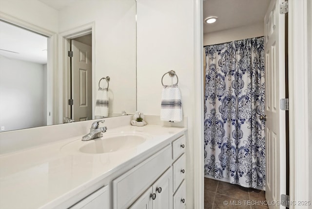 bathroom with a shower with shower curtain, tile patterned flooring, and vanity