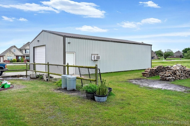 view of pole building featuring fence, a yard, and a wall unit AC