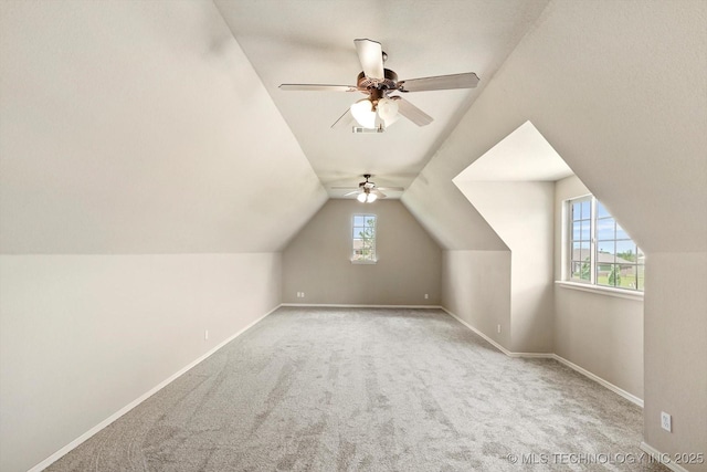 bonus room with ceiling fan, visible vents, baseboards, lofted ceiling, and carpet