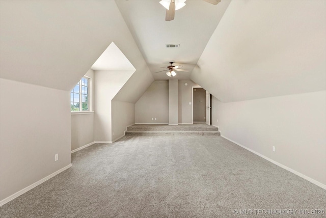 additional living space featuring carpet floors, a ceiling fan, baseboards, and lofted ceiling