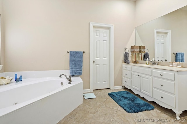 bathroom with tile patterned floors, a garden tub, and vanity