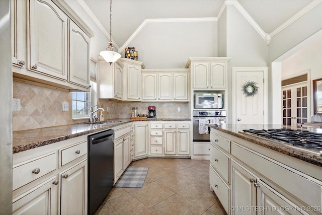 kitchen featuring french doors, a sink, dark stone countertops, backsplash, and stainless steel appliances