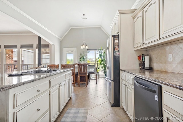 kitchen featuring light stone countertops, a notable chandelier, appliances with stainless steel finishes, decorative light fixtures, and backsplash